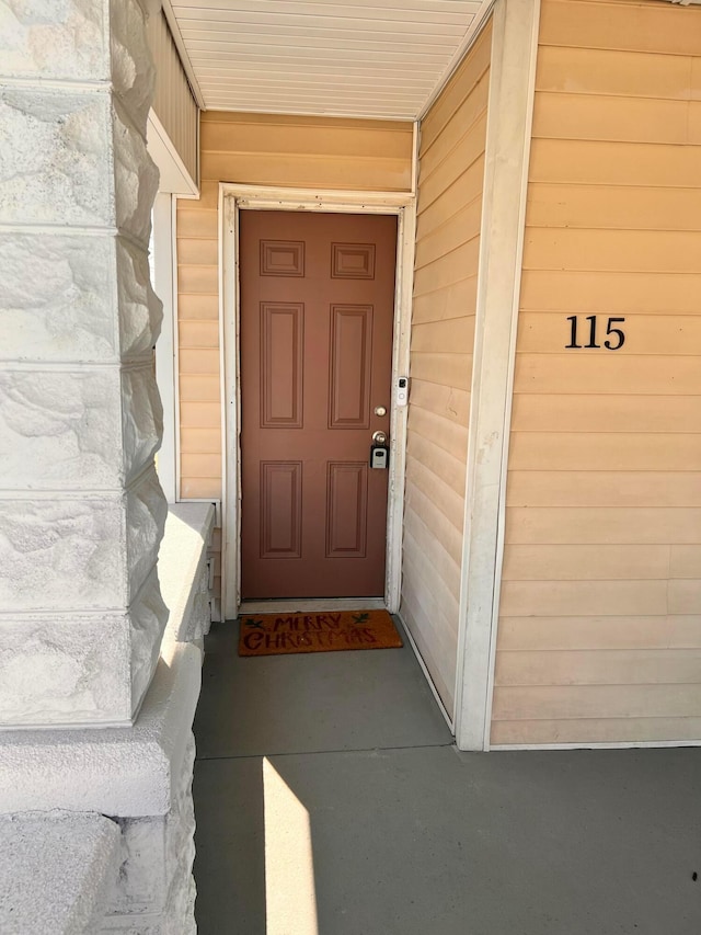 property entrance with stone siding