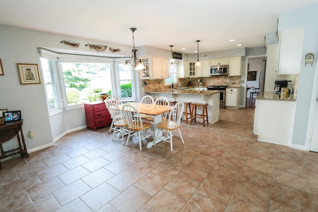 dining room featuring baseboards and recessed lighting