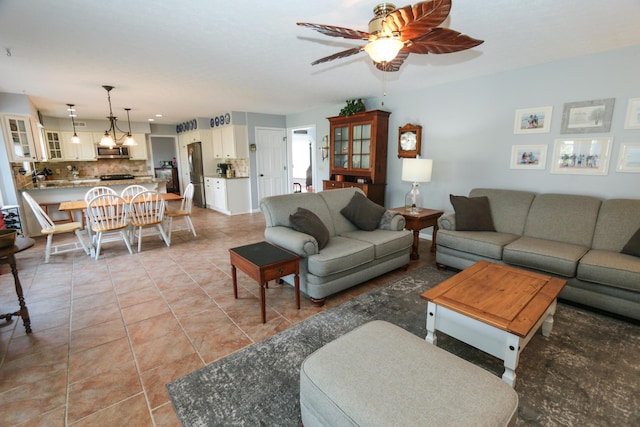 living room featuring light tile patterned floors and ceiling fan