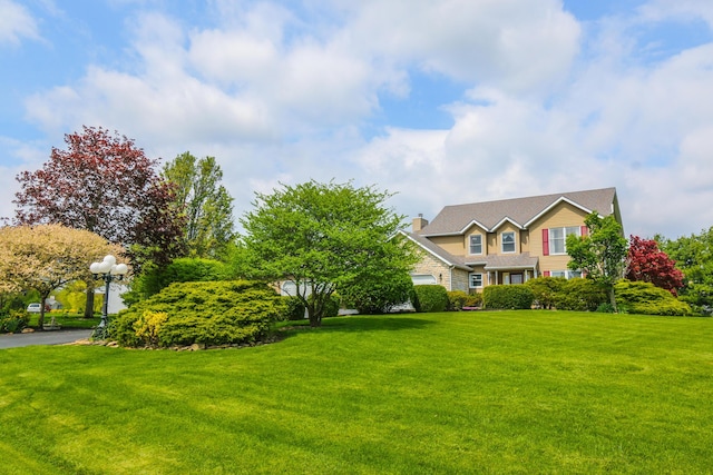 view of front of home featuring a chimney and a front yard