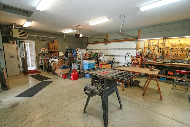garage featuring a workshop area and a garage door opener