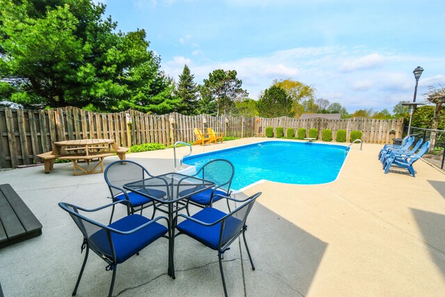 view of swimming pool with a patio, a fenced in pool, and a fenced backyard