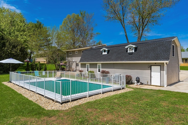 view of pool with fence, a fenced in pool, and a lawn