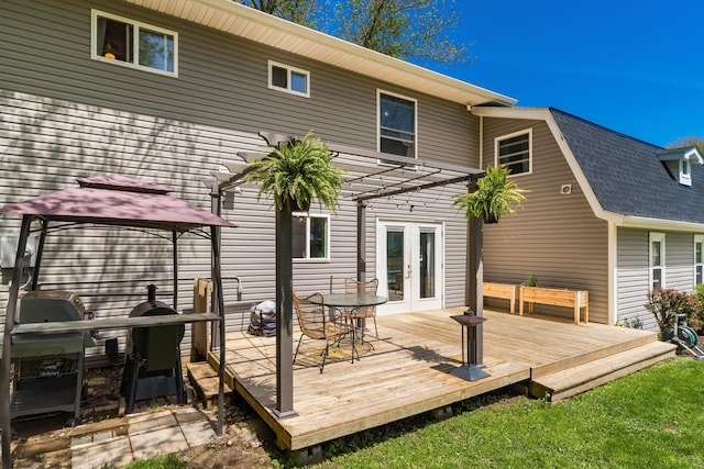 rear view of house with french doors, roof with shingles, a gazebo, and a deck