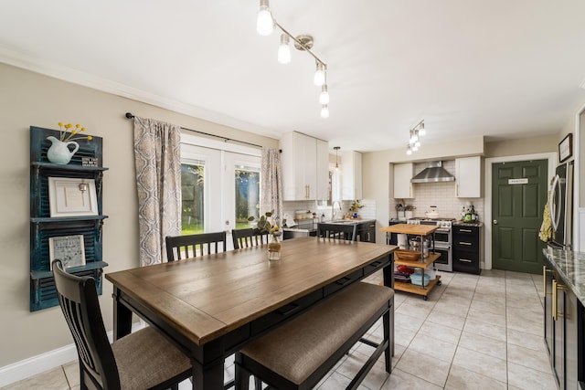 dining room with rail lighting and light tile patterned flooring