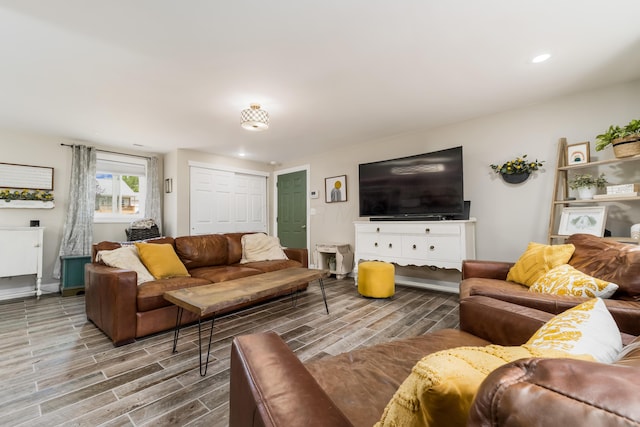 living room featuring recessed lighting, baseboards, and wood tiled floor