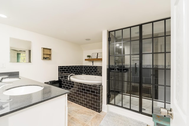 full bath featuring double vanity, a tile shower, a sink, and a garden tub