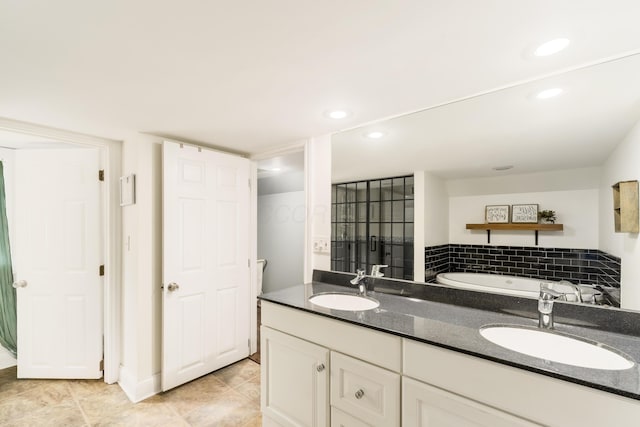 full bathroom featuring double vanity, a sink, a tub, and recessed lighting