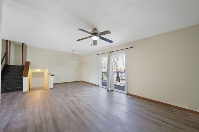 unfurnished living room featuring baseboards, a ceiling fan, wood finished floors, and visible vents