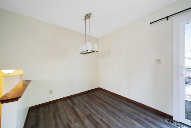 unfurnished dining area featuring baseboards, visible vents, and dark wood-style floors