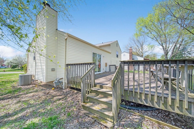 exterior space featuring central air condition unit, a deck, and a chimney