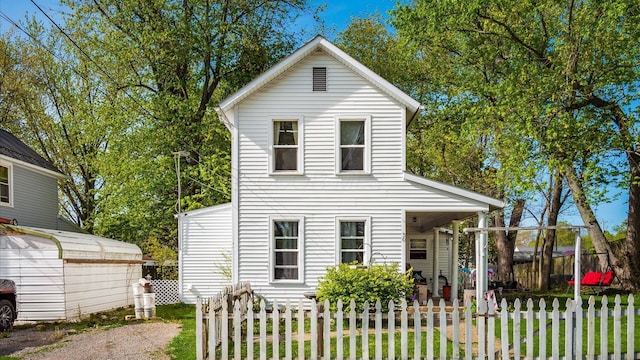 traditional-style house with fence private yard and a front yard