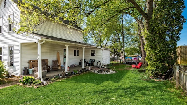 back of property featuring a lawn and a fenced backyard