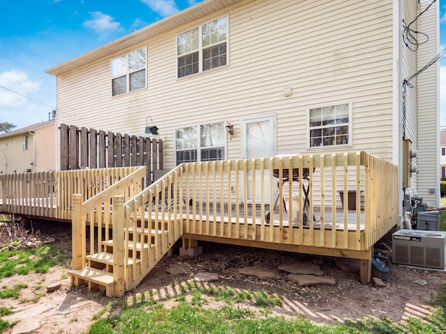 back of house with a wooden deck and central AC