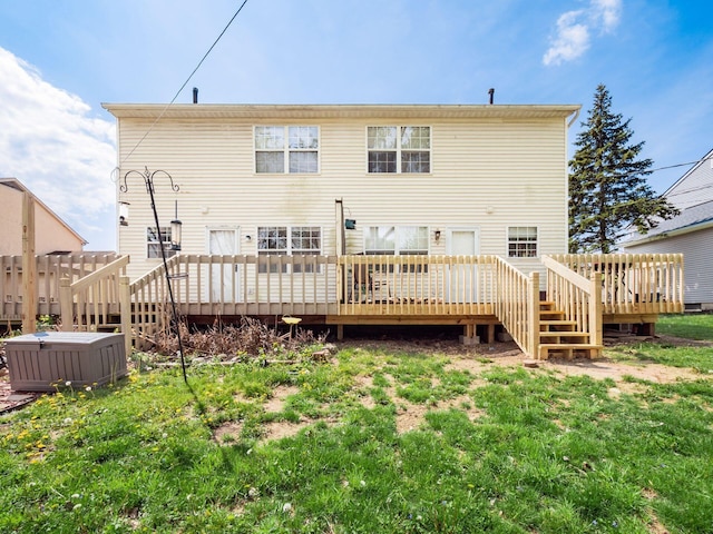 rear view of property with a yard and a deck