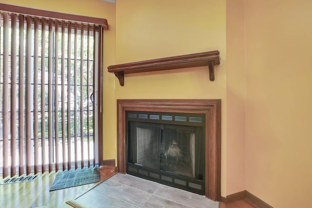 interior details featuring baseboards and a fireplace with flush hearth