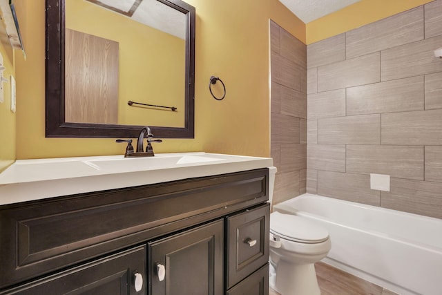 bathroom with vanity, shower / tub combination, wood finished floors, and toilet