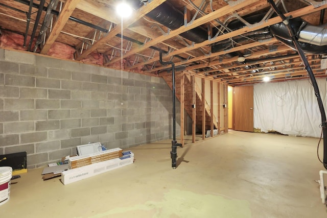 unfinished basement with concrete block wall