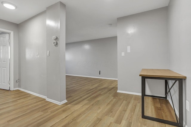 interior space with light wood-style floors and baseboards