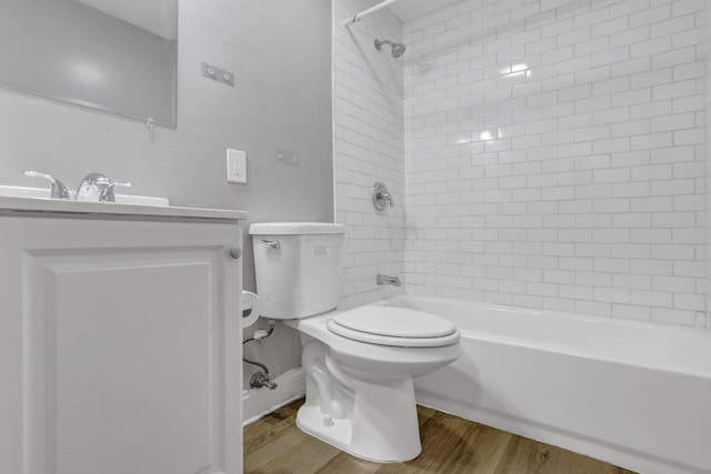 full bath featuring toilet, shower / tub combination, wood finished floors, and vanity