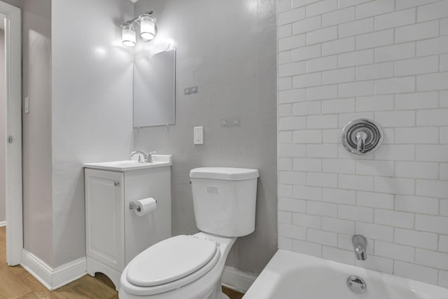 full bathroom with shower / bath combination, wood finished floors, vanity, baseboards, and toilet