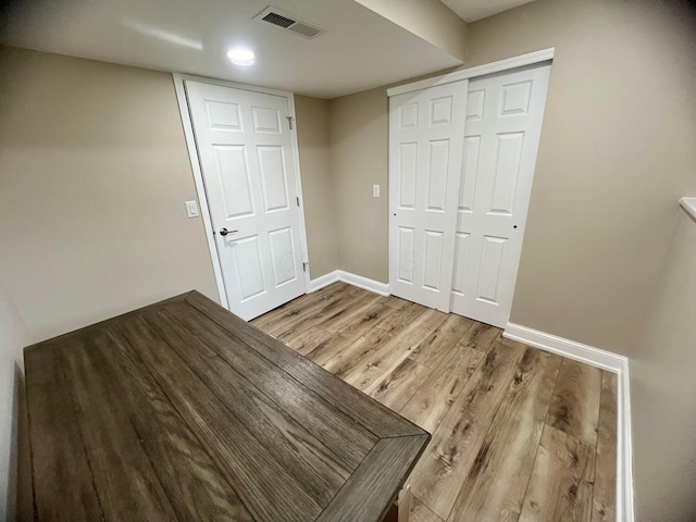 357 Carroll Eastern Rd NW, Baltimore, OH 43105 - unfurnished bedroom with light wood-style flooring, baseboards, a closet, and visible vents