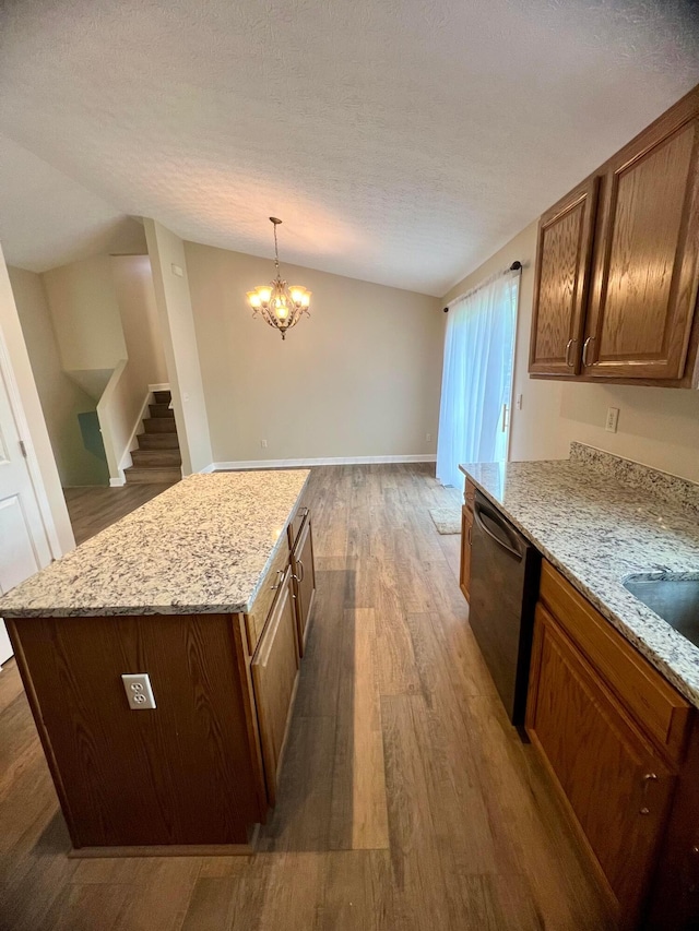 357 Carroll Eastern Rd NW, Baltimore, OH 43105 - kitchen with a textured ceiling, a center island, light stone counters, dishwashing machine, and wood finished floors