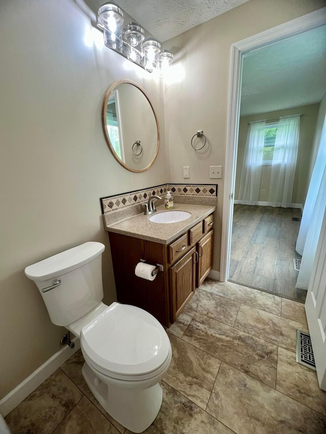 357 Carroll Eastern Rd NW, Baltimore, OH 43105 - bathroom with vanity, toilet, baseboards, and visible vents