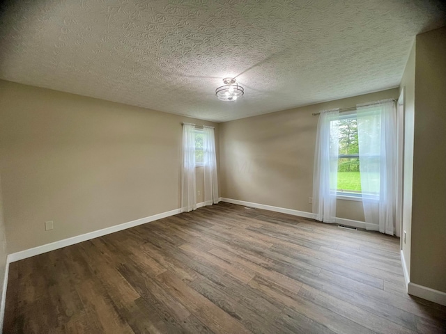357 Carroll Eastern Rd NW, Baltimore, OH 43105 - spare room with a textured ceiling, baseboards, visible vents, and wood finished floors