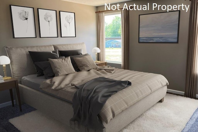bedroom featuring baseboards and carpet flooring