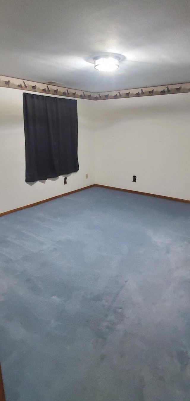 spare room featuring baseboards