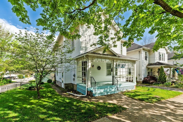 22 Elizabeth St, Delaware, OH 43015 - view of front of property with a porch, fence, and a front yard