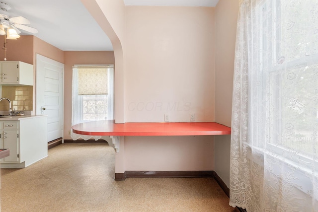 22 Elizabeth St, Delaware, OH 43015 - unfurnished office featuring baseboards, a ceiling fan, a sink, and arched walkways