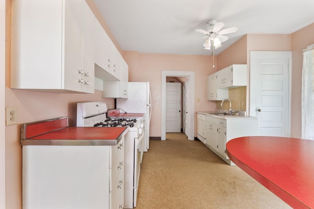 22 Elizabeth St, Delaware, OH 43015 - kitchen featuring white cabinets, light colored carpet, a sink, white appliances, and a ceiling fan