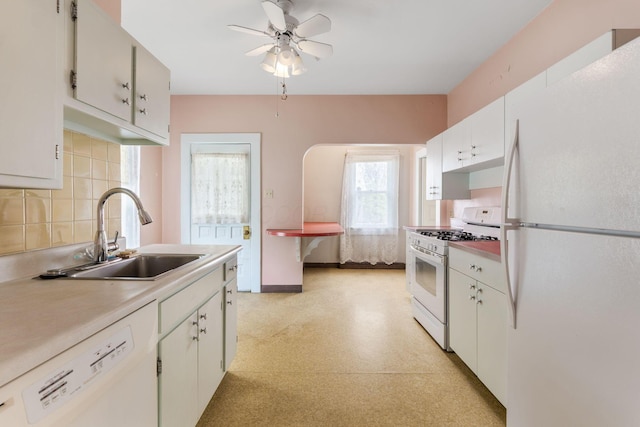 22 Elizabeth St, Delaware, OH 43015 - kitchen featuring decorative backsplash, ceiling fan, a sink, light countertops, and white appliances