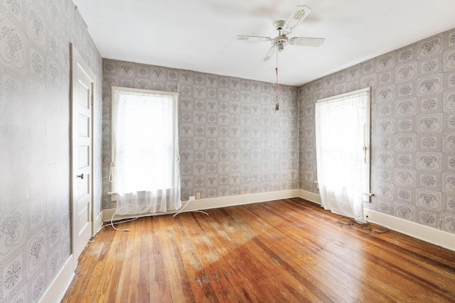 22 Elizabeth St, Delaware, OH 43015 - unfurnished room featuring wood-type flooring, baseboards, ceiling fan, and wallpapered walls