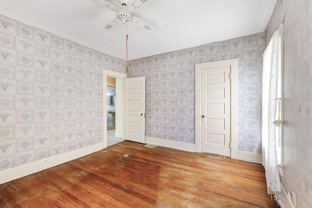 22 Elizabeth St, Delaware, OH 43015 - unfurnished room with wallpapered walls, ceiling fan, and hardwood / wood-style flooring