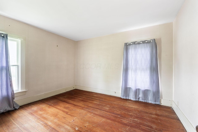22 Elizabeth St, Delaware, OH 43015 - unfurnished room with baseboards, plenty of natural light, and hardwood / wood-style floors