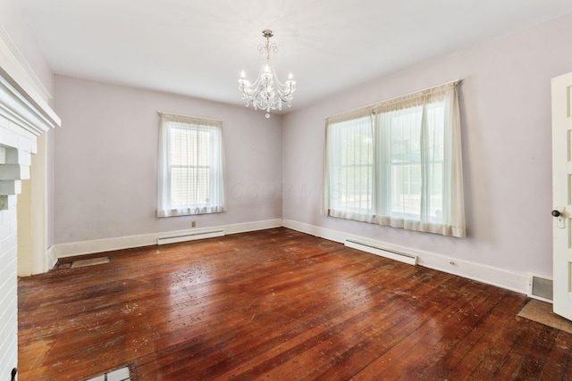 22 Elizabeth St, Delaware, OH 43015 - spare room featuring a notable chandelier, a baseboard heating unit, baseboard heating, and hardwood / wood-style flooring