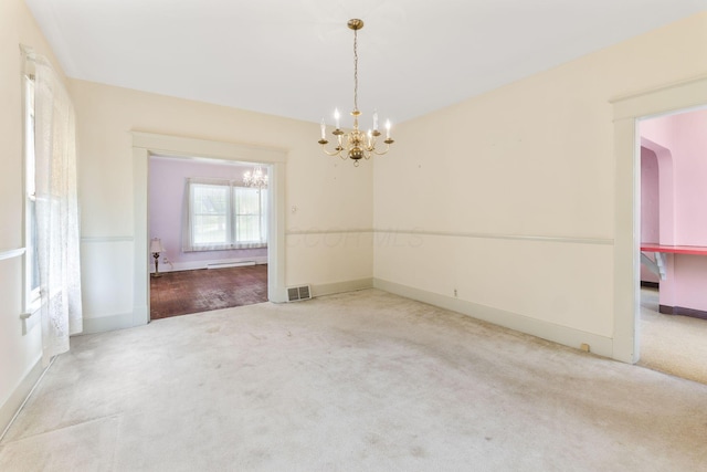 22 Elizabeth St, Delaware, OH 43015 - spare room featuring visible vents, carpet flooring, baseboards, and a chandelier