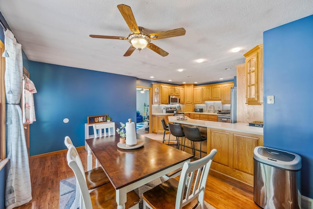 1083 Martha Ave, Bucyrus, OH 44820 - dining room with light wood-type flooring, recessed lighting, baseboards, and ceiling fan
