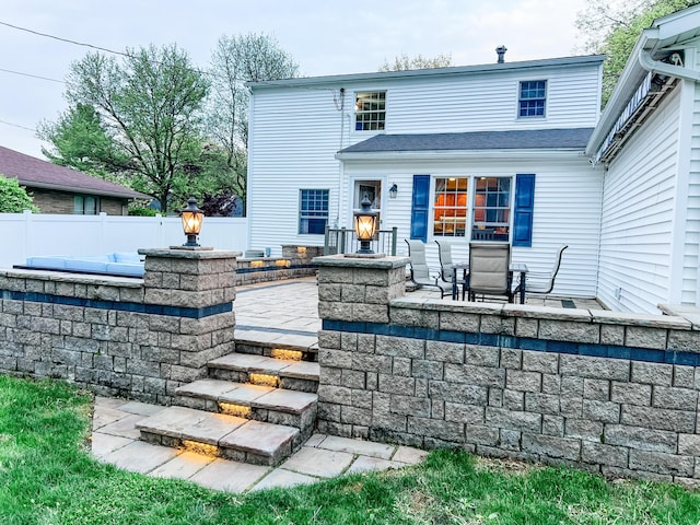 1083 Martha Ave, Bucyrus, OH 44820 - back of property featuring fence, a shingled roof, and a patio area