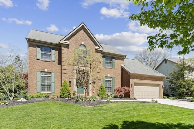 colonial house with concrete driveway, brick siding, an attached garage, and a front lawn