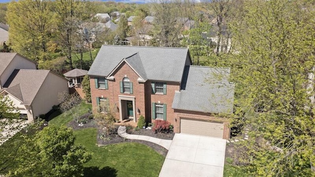 view of front facade with driveway, a front lawn, and a garage