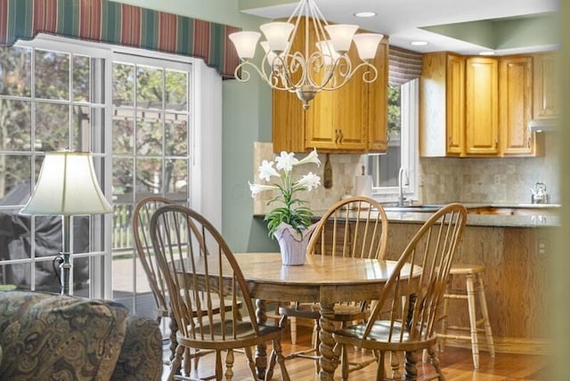 dining area with a notable chandelier and wood finished floors