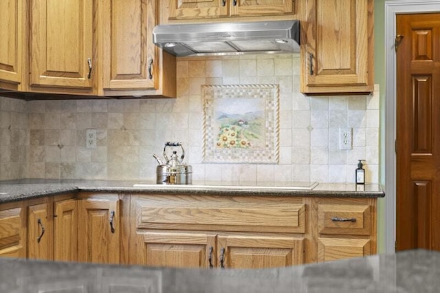 kitchen with brown cabinetry, decorative backsplash, and ventilation hood
