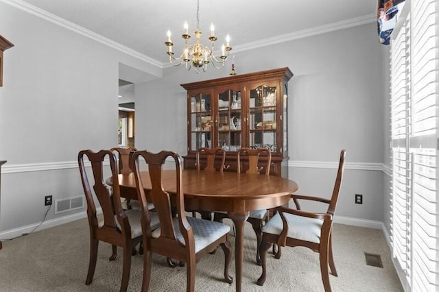 dining room with visible vents, baseboards, a notable chandelier, and light colored carpet