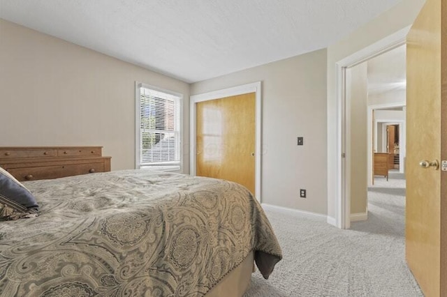 bedroom featuring baseboards and carpet