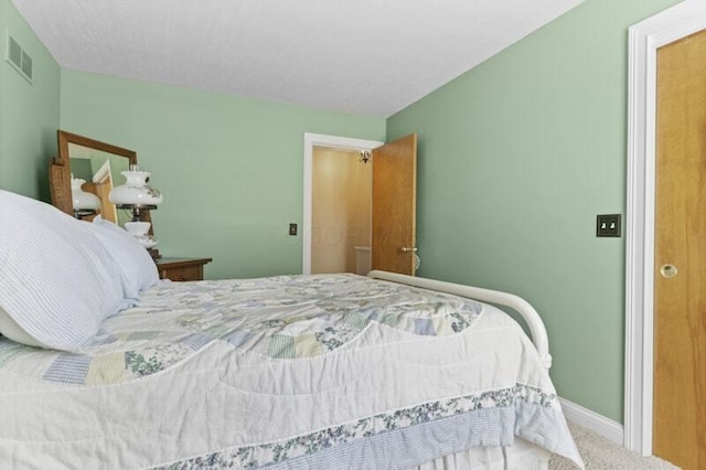 bedroom featuring visible vents, carpet, and baseboards