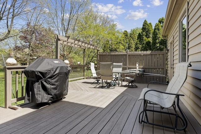 wooden deck featuring outdoor dining space, grilling area, and a pergola